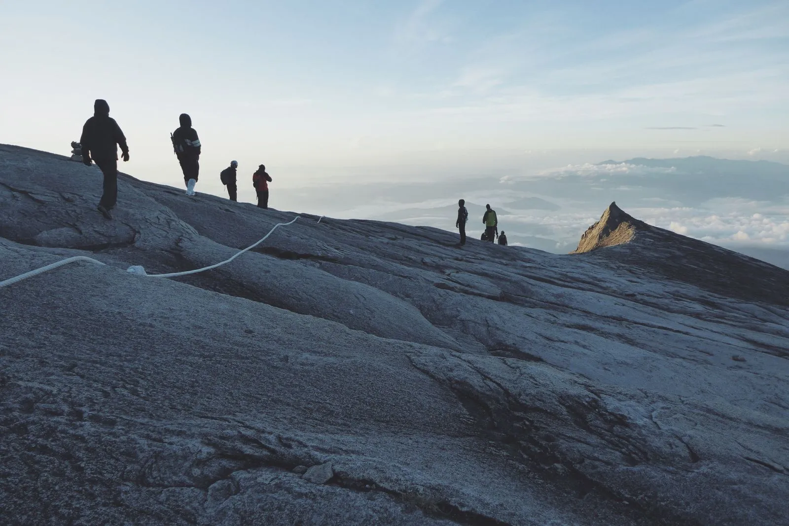 Climbers on the summit plateau at dawn, with South Peak to the right