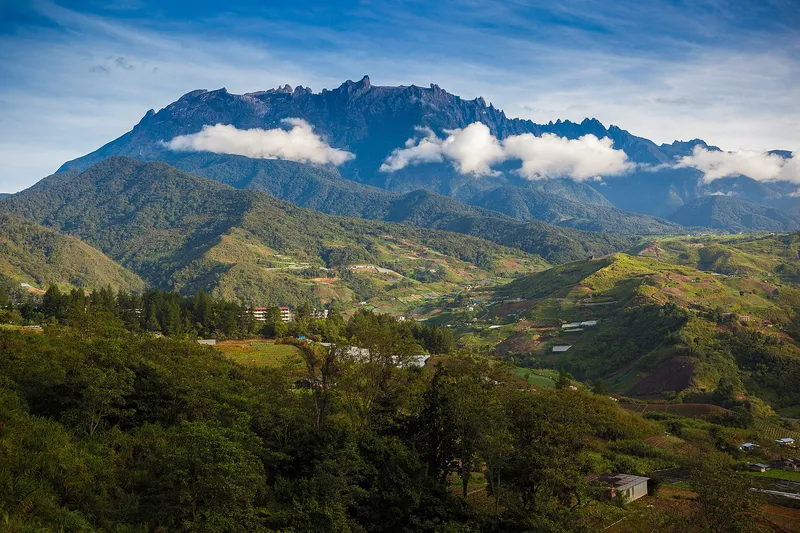 Mount Kinabalu above the farms and hills of Kundasang on a clear morning