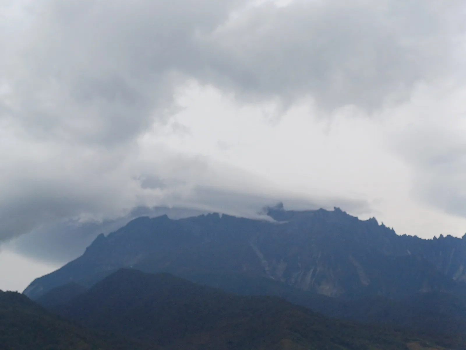 Mount Kinabalu under heavy cloud, seen from Kundasang