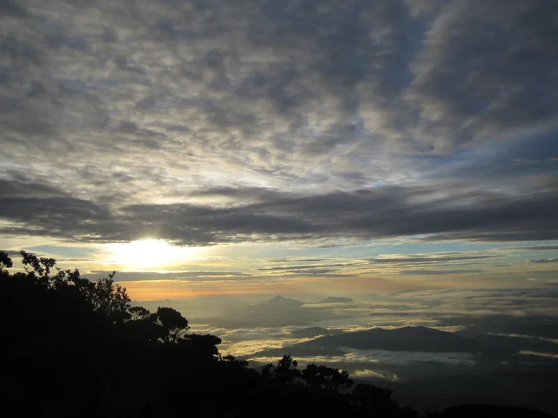 Sunrise over a sea of cloud seen from the upper slopes of Mount Kinabalu